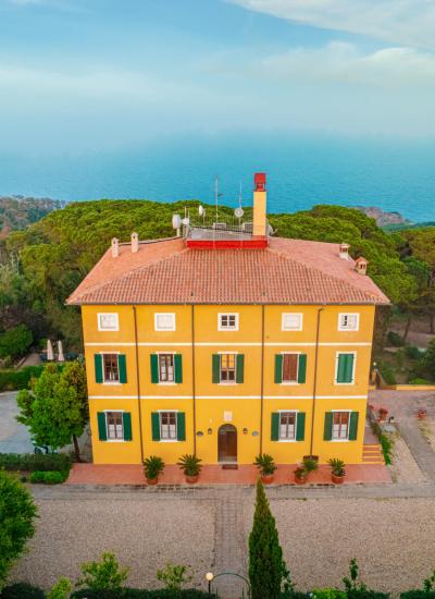 Yellow villa with red roof, sea view and garden.